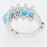 Sterling silver ring with oval blue turquoise and intricate design, showcasing fine craftsmanship and elegance.